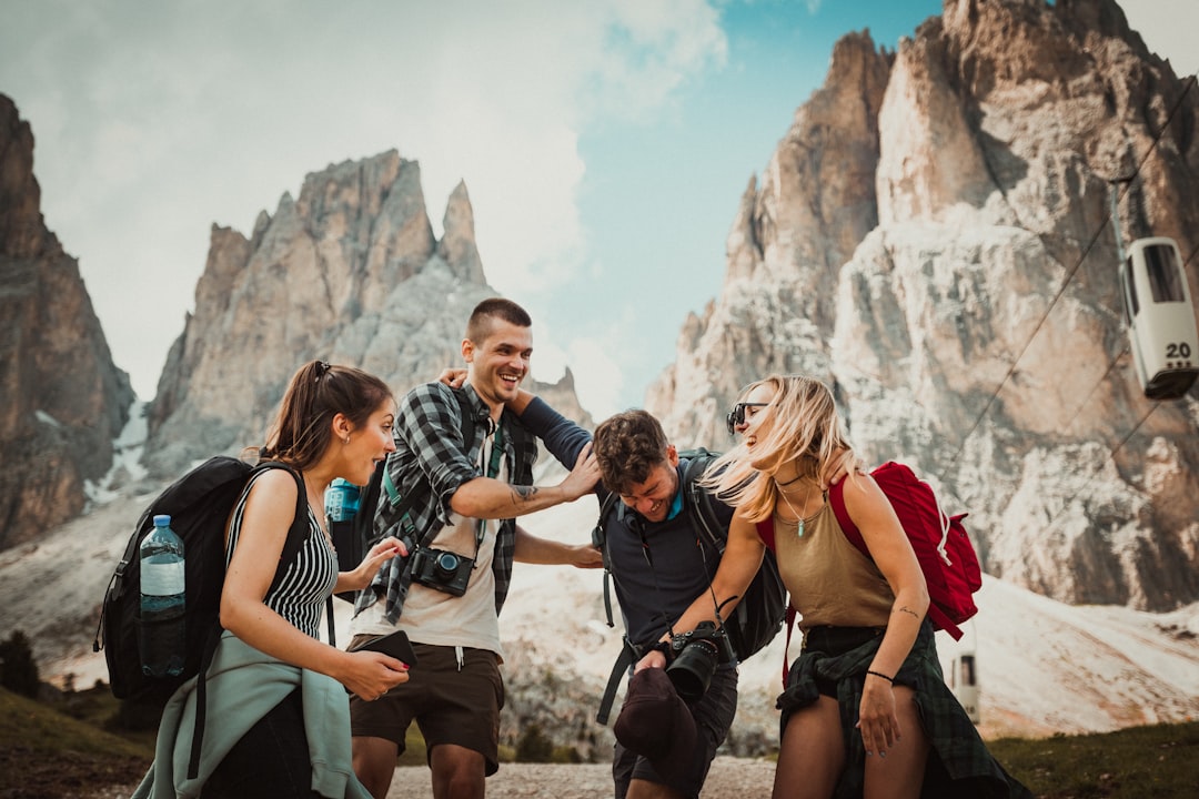Photo by Felix Rostig low-angle photography of two men playing beside two women